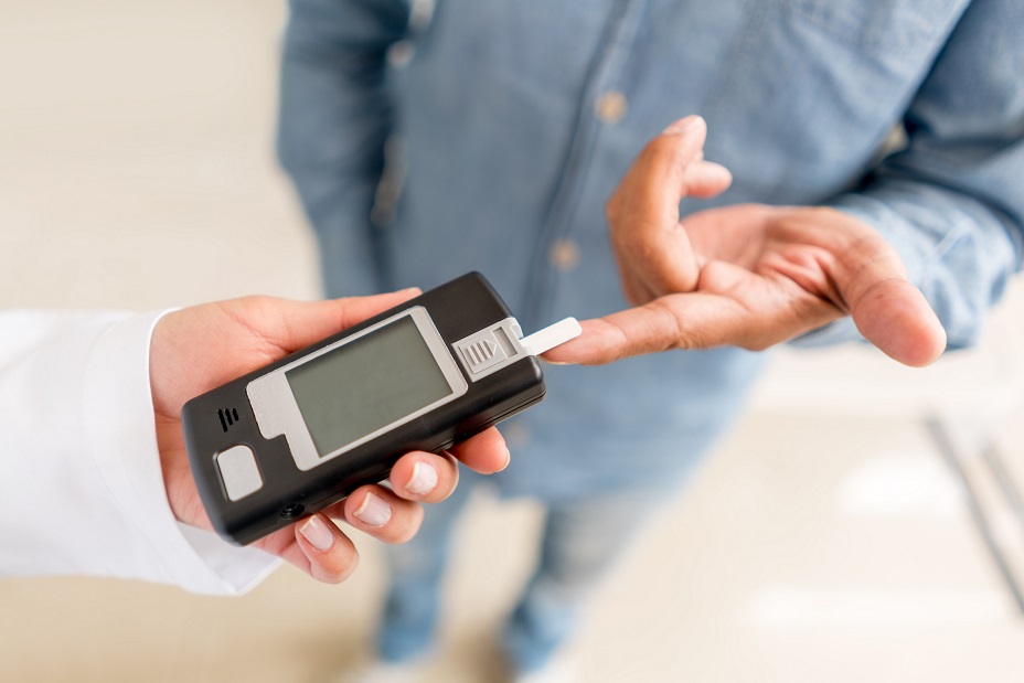 Patient checking sugar level with glucometer